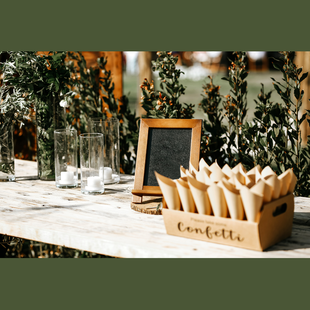 Confetti cones in a tray with glass cylinder and votive candles. Small Chalkboard